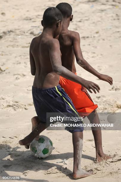 Somali Children play football on the Lido beach in Mogadishu, on January 12, 2018. / AFP PHOTO / Mohamed ABDIWAHAB