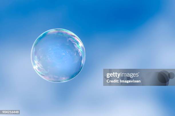 soap bubble floating in a blue sky - soap sud 個照片及圖片檔