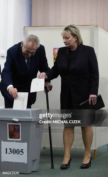 Czech President Milos Zeman and his wife Ivana cast their ballots at a polling station in Prague on January 12, 2018. The first round of the...