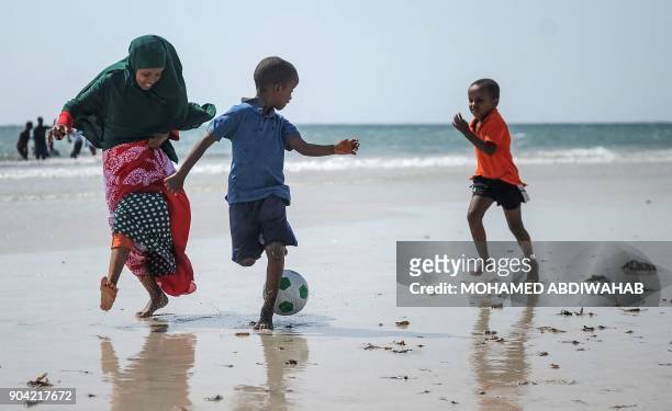 Somali children play football on the Lido beach in Mogadishu, on January 12, 2018.