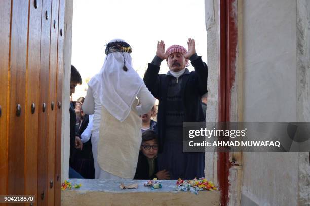 Iraqi Yazidis visit their temple during a ceremony on January 12 in the town of Bashiqa, some 20 kilometres north east of Mosul. / AFP PHOTO / Ahmad...