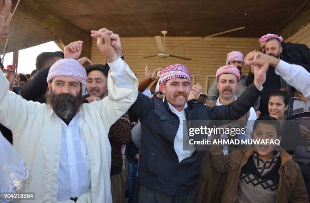 Iraqi Yazidis visit their temple during a ceremony on January 12 in the town of Bashiqa, some 20 kilometres north east of Mosul. / AFP PHOTO / Ahmad...