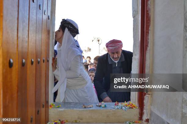 Iraqi Yazidis visit their temple during a ceremony on January 12 in the town of Bashiqa, some 20 kilometres north east of Mosul. / AFP PHOTO / Ahmad...