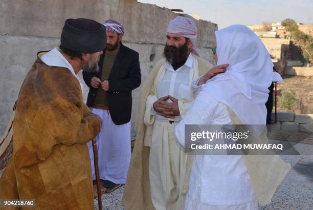 Iraqi Yazidis visit their temple during a ceremony on January 12 in the town of Bashiqa, some 20 kilometres north east of Mosul. / AFP PHOTO / Ahmad...