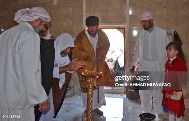 Iraqi Yazidis visit their temple during a ceremony on January 12 in the town of Bashiqa, some 20 kilometres north east of Mosul. / AFP PHOTO / Ahmad...