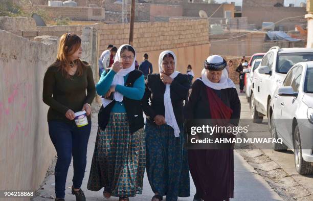 Iraqi Yazidis visit their temple during a ceremony on January 12 in the town of Bashiqa, some 20 kilometres north east of Mosul. / AFP PHOTO / Ahmad...