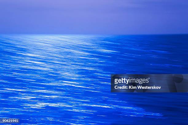 moonlight reflections on open sea, blurred motion  - westerskov stock pictures, royalty-free photos & images