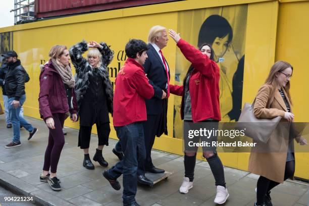 The waxwork of Donald Trump is carried to the US Embassy at Nine Elms in south London on the day when the President announced on Twitter, his refusal...