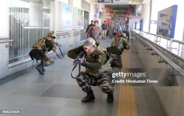 Haryana Police personnel and Central Industrial Security Force in action during the joint mock drill at MG road metro station ahead of Republic Day...