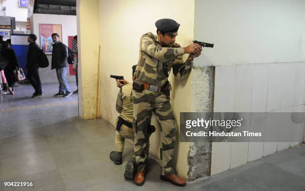 Haryana Police personnel and Central Industrial Security Force in action during the joint mock drill at MG road metro station ahead of Republic Day...
