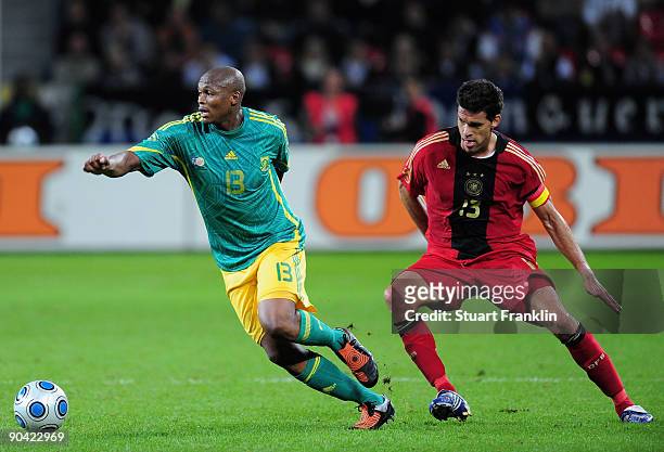 Michael Ballack of Germany challenges Kagisho Dikgacoi of South Africa during the international friendly match between Germany and South Africa at...