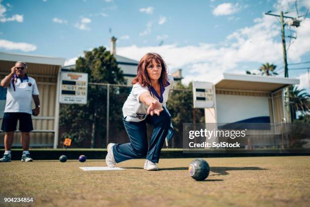 mature woman playing bowls - lawn bowling stock pictures, royalty-free photos & images
