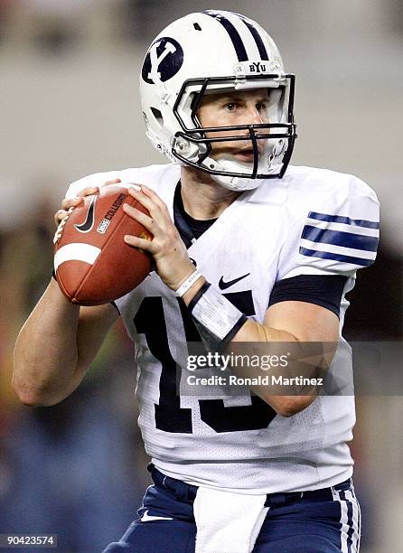 Quarterback Max Hall of the Brigham Young Cougars drops back to pass against the Oklahoma Sooners at Cowboys Stadium on September 5, 2009 in...