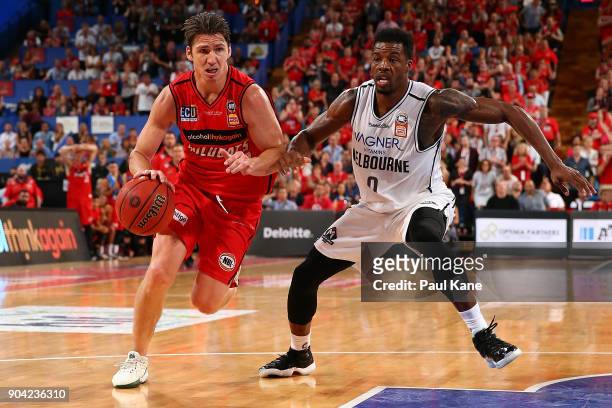 Damian Martin of the Wildcats drives to the keyway against Carrick Felix of United during the round 14 NBL match between the Perth Wildcats and...