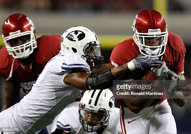 Running back DeMarco Murray of the Oklahoma Sooners runs against Brandon Bradley of the Brigham Young Cougars at Cowboys Stadium on September 5, 2009...
