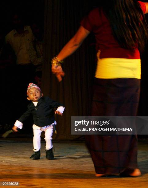 Nepalese teenager Khagendra Thapa Magar who weighs around 4.5 kg and is 51 cm tall, dances at a function in Kathmandu on September 7, 2009. Magar...