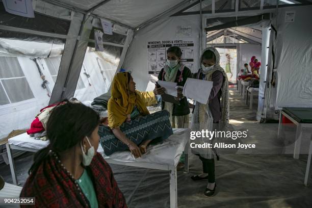 Rohingya refugees are treated by nurses at a Samaritan's Purse diphtheria clinic in Balukhali camp on January 12, 2018 in Cox's Bazar, Bangladesh....