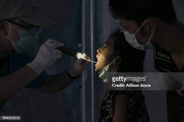 Rohingya refugee is examined by a doctor at a Samaritan's Purse diphtheria clinic in Balukhali camp on January 12, 2018 in Cox's Bazar, Bangladesh....