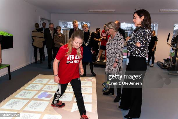 Crown Princess Mary of Denmark in the exercise room, where she watch a girl exercising on an 'Active Floor' during her visit to the Christmas Seal...