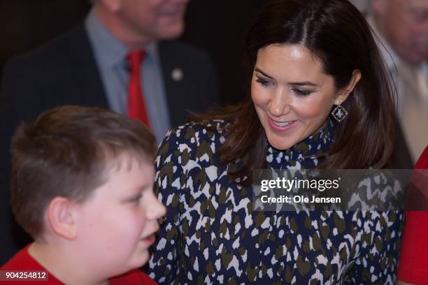 Crown Princess Mary of Denmark speaks to a young boy during her visits to the Christmas Seal Foundation home opening on January 12, 2018 in Roskilde,...