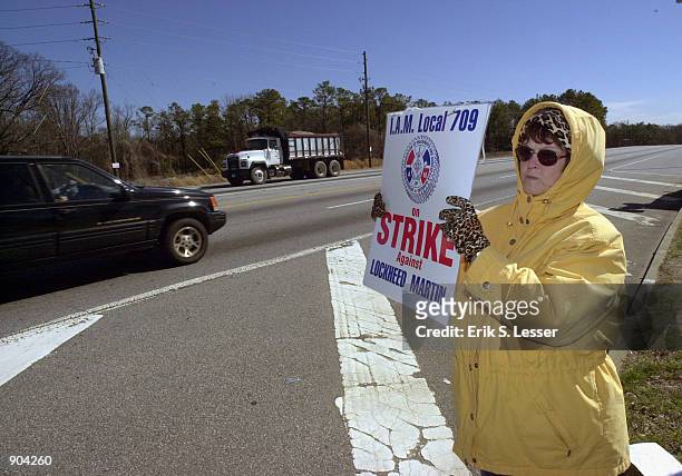 Member of the International Association of Machinists Local 709 walks the picket line March 11, 2002 in front of the Lockheed Martin aircraft...