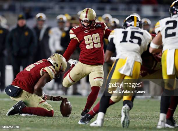 Colton Lichtenberg of the Boston College Eagles kicks a field goal against the Iowa Hawkeyes during the first half of the New Era Pinstripe Bowl at...
