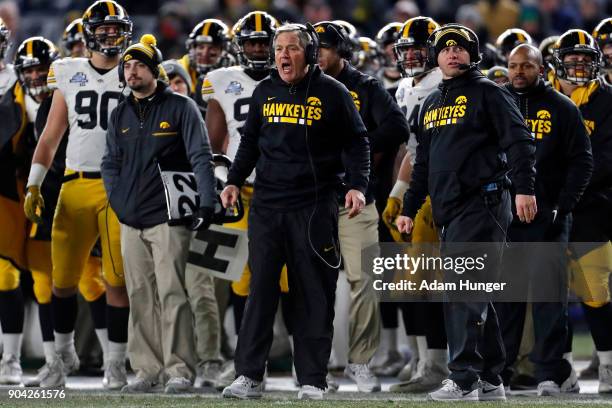 Head coach Kirk Ferentz of the Iowa Hawkeyes directs his team against the Boston College Eagles during the first half of the New Era Pinstripe Bowl...