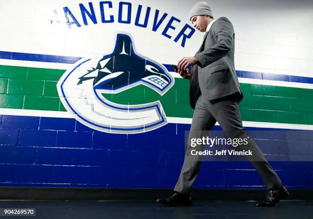 Ben Hutton of the Vancouver Canucks walks to his dressing room during their NHL game against the Calgary Flames at Rogers Arena December 17, 2017 in...