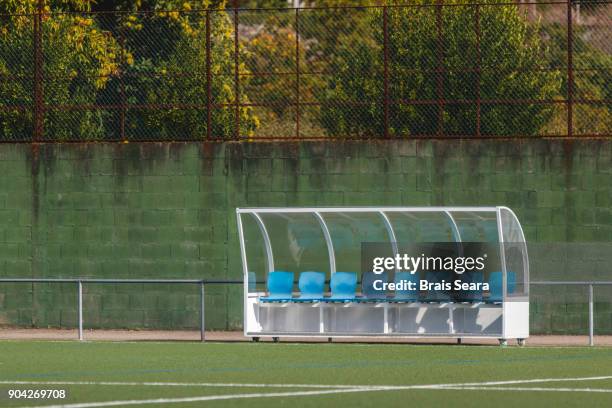 bench with blue seats with no one - football bench stock pictures, royalty-free photos & images