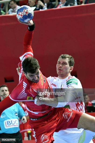 Maxim Babichev of Belarus vies for the ball with Janko Bozovic of Austria during the preliminary round group B match of the Men's 2018 EHF European...