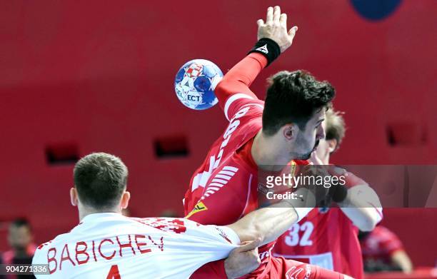 Janko Bozovic of Austria vies for the ball with Maxim Babichev of Belarus during the preliminary round group B match of the Men's 2018 EHF European...