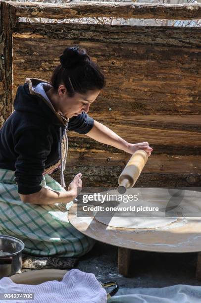 Armenia, Kotayk Province, Garni, Lavash is the typical Armenian bread. A wafer-thin dough is glued to the inside of a wood-fired stone oven. The...