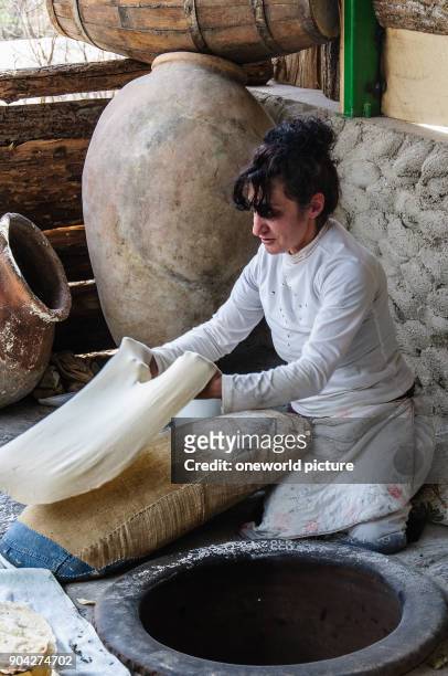 Armenia, Kotayk Province, Garni, Lavash is the typical Armenian bread. A wafer-thin dough is glued to the inside of a wood-fired stone oven. The...