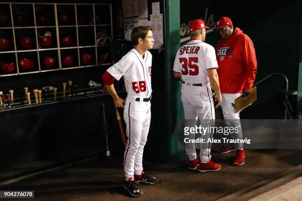 Manager Dusty Baker speaks with bench coach Chris Speier of the Washington Nationals in the dugout prior to Game 1 of the National League Division...
