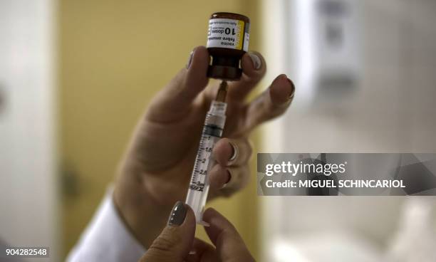Nurse prepares a vaccine against yellow fever at an outpatient clinic in Sao Paulo, Brazil, on January 12, 2018. Brazil stepped up prevention...