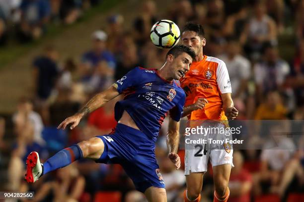 Jason Hoffman of the Jets and Connor O'Toole of the Roar contest a header during the round 16 A-League match between the Newcastle Jets and the...
