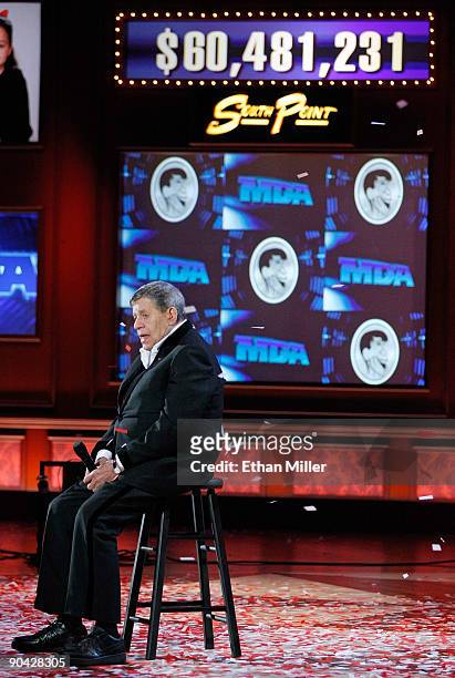 Entertainer Jerry Lewis appears in front of the tote board displaying the USD 60 231 raised during the 44th annual Labor Day Telethon to benefit the...