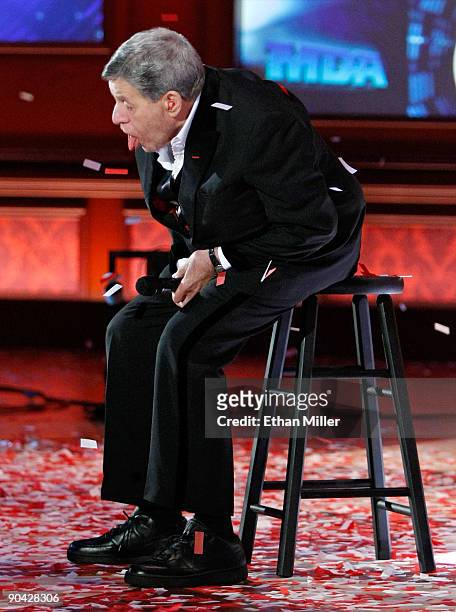Entertainer Jerry Lewis tries to catch confetti with his tongue at the end of the 44th annual Labor Day Telethon to benefit the Muscular Dystrophy...