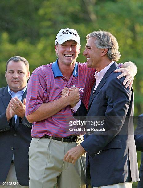Steve Stricker laughs with Seth Waugh, CEO of Deutsche Bank America, after Stricker won the the Deutsche Bank Championship held at TPC Boston on...