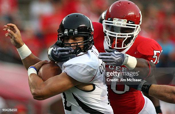 David Osei of the Rutgers Scarlet Knights tackles Zach Collaros of the Cincinnati Bearcats at Rutgers Stadium on September 7, 2009 in Piscataway, New...