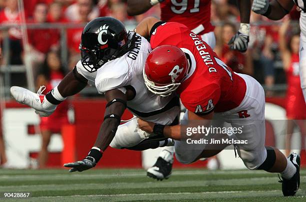 Ryan D'Imperio of the Rutgers Scarlet Knights tackles Mardy Gilyard of the Cincinnati Bearcats at Rutgers Stadium on September 7, 2009 in Piscataway,...
