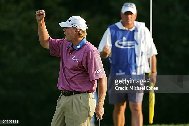 Steve Stricker celebrates with his caddie Jimmy Johnson after his winning putt on the 18th green during the final round of the Deutsche Bank...