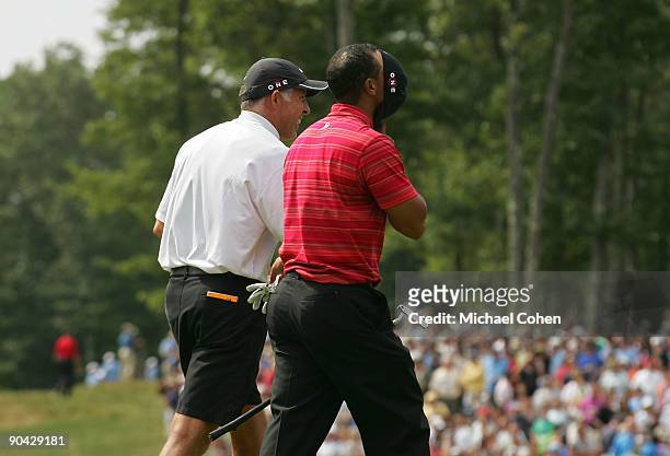 Tiger Woods reacts as he leaves the 18th green after shootingf a 63 during the final round of the Deutsche Bank Championship at TPC Boston held on...
