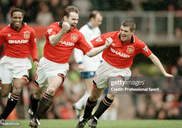 Brian McClair of Manchester United celebrates with teammates Roy Keane and Paul Ince after scoring during the FA Cup 5th Round match between...