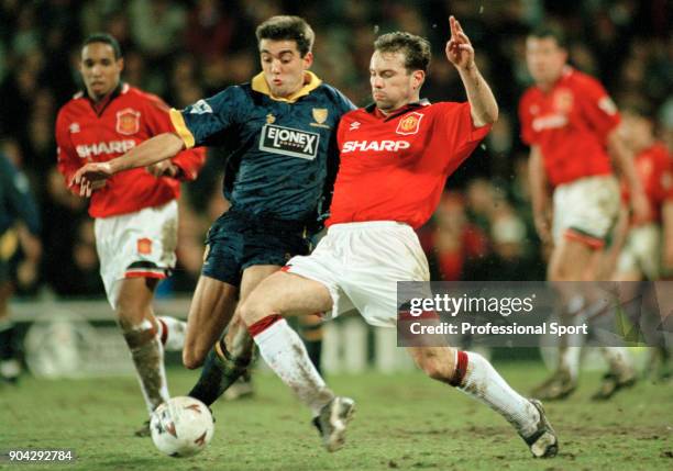 Brian McClair of Manchester United tackles Jon Goodman of Wimbledon during an FA Carling Premiership match at Selhurst Park on March 07, 1995 in...