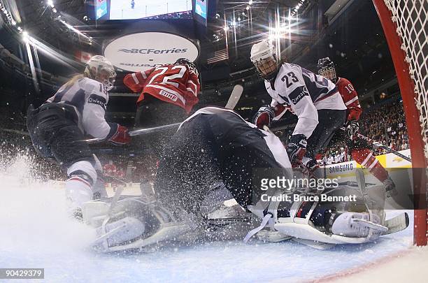 Goaltender Molly Schaus of Team USA tends net with the help of Kerry Weiland against Team Canada during the Hockey Canada Cup at General Motors Place...