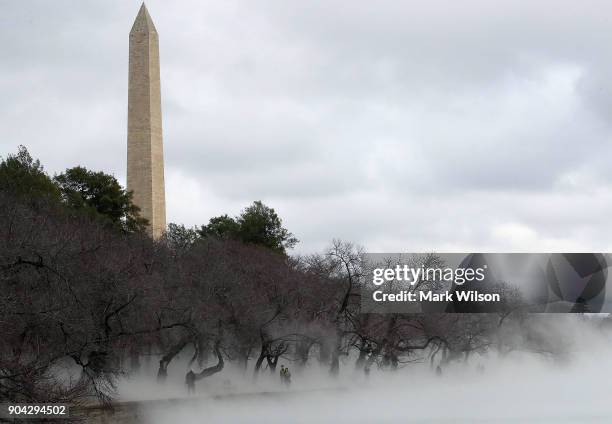 Warm weather causes fog to rise from the ice on the Tidal Basin near the Washington Monument on January 12, 2018 in Washington, DC.