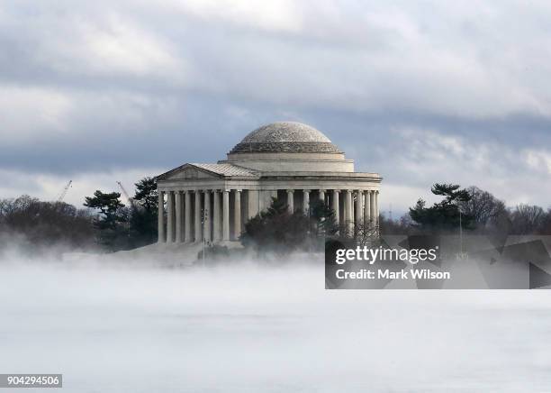 Warm weather causes fog to rise from the ice on the Tidal Basin near the Jefferson Memorial on January 12, 2018 in Washington, DC.