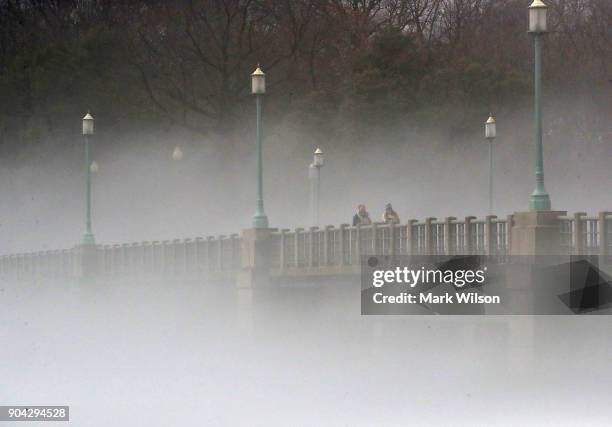 Warm weather causes fog to rise from the ice on the Tidal Basin near the Kutz Bridge on January 12, 2018 in Washington, DC.