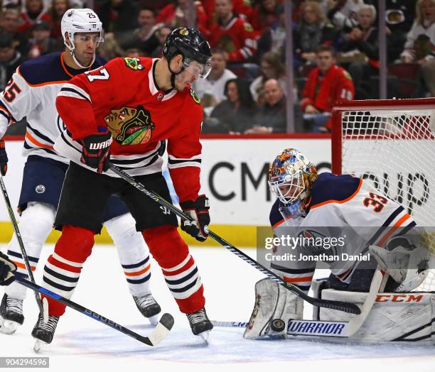 Cam Talbot of the Edmonton Oilers makes a save against Lance Bouma of the Chicago Blackhawks at the United Center on January 7, 2018 in Chicago,...